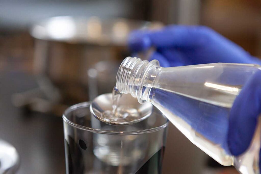 Close Up Woman Pouring Water From A Plastic Bottl